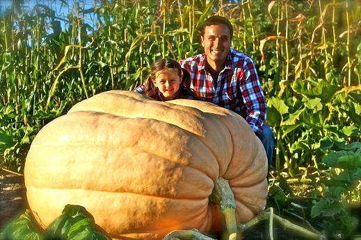 Charlie Lopresti and his daughter pose with the award winner in his pumpkin patch